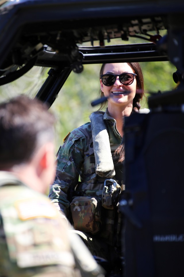Capt. Lyndsey Thurston, UH-60 Blackhawk Pilot with Charlie Company, 1st Battalion, 140th Aviation, 96th Troop Command, Washington Army National Guard jokes with CW3 Jarin Trakel prior to conducting water bucket training with Central Pierce Fire...