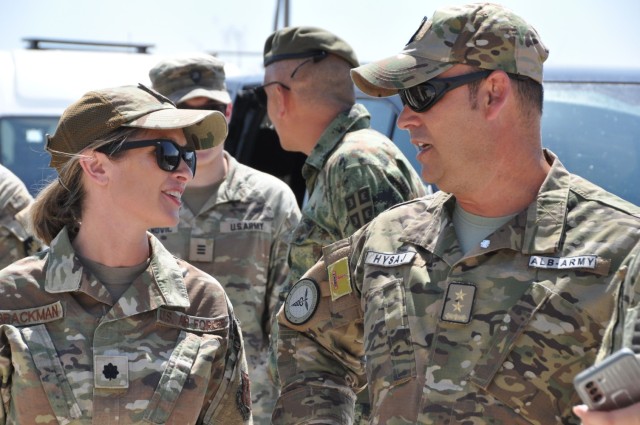 U.S. Air Force Lt. Col. Shelly Brackman, Ohio National Guard medical liaison for the State Partnership Program, and Lt. Col. Melsi Hysaj, S7 Balkan Medical Task Force, Armed Forces of Albania, chat after watching a military demonstration during...
