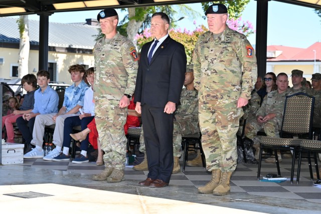 VICENZA, Italy - Col. Scott W. Horrigan, outgoing commander of U.S. Army Garrison Italy, left, Mr. Tommy R. Mize, Installation Management Command Europe Region Director, center, and Col. Vaughn D. Strong Jr., incoming commander, right, prepare to...