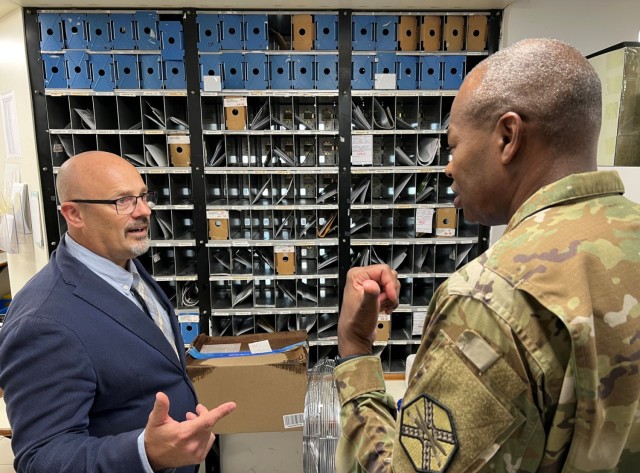 Lonnie Heuer, Director of Human Resources at USAG Italy, discusses postal operations with Maj. Gen. James Smith, acting commander of U.S. Army Installation Management Command, during his Aug. 1 visit to Caserma Ederle.
