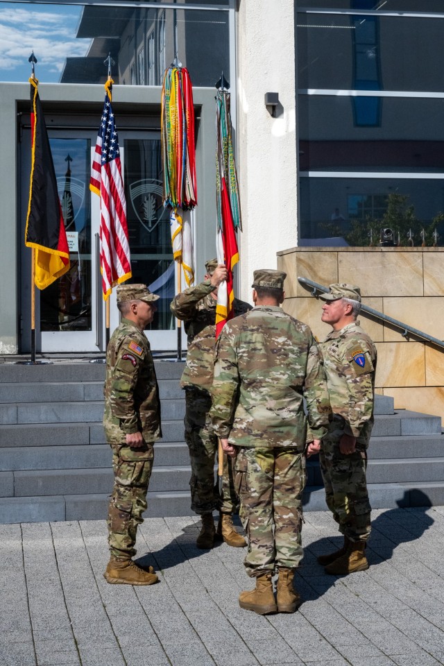 Command Sgt. Maj. Jeremiah E. Inman, outgoing senior enlisted advisor, and Command Sgt. Maj. Christopher L. Mullinax, incoming senior enlisted advisor, participate in the passing of the colors during a change of responsibility ceremony at Clay...